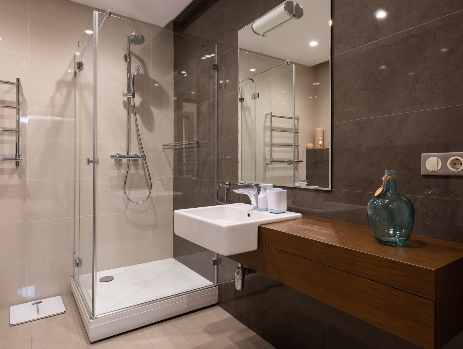 Glass shower enclosure and stone tile detail in a finished bathroom — stock detail photo